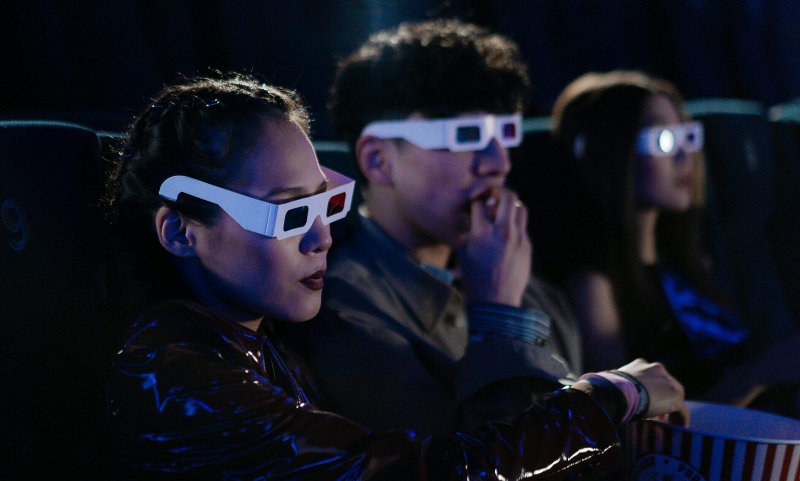 Movie goers watching an imax movie with 3d glasses.
